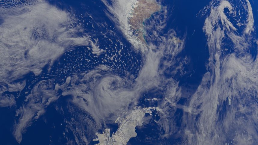 Vista da Terra a partir do espaço, com oceanos e extensas formações de nuvens na atmosfera.